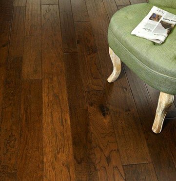 green chair on top of hardwood flooring